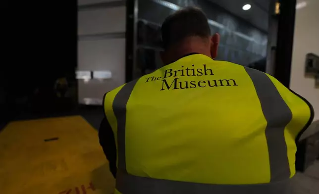 A British Museum worker unloads objects out of a truck at the British Museum in London, Friday, July 10, 2026. (AP Photo/Kwiyeon Ha)