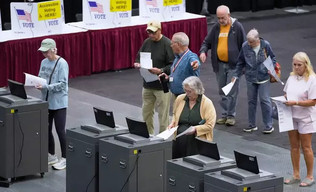 FILE - Voter cast their Maine primary ballots at the Civic Center, June 9, 2026, in Augusta, Maine. (AP Photo/Robert F. Bukaty, File)
