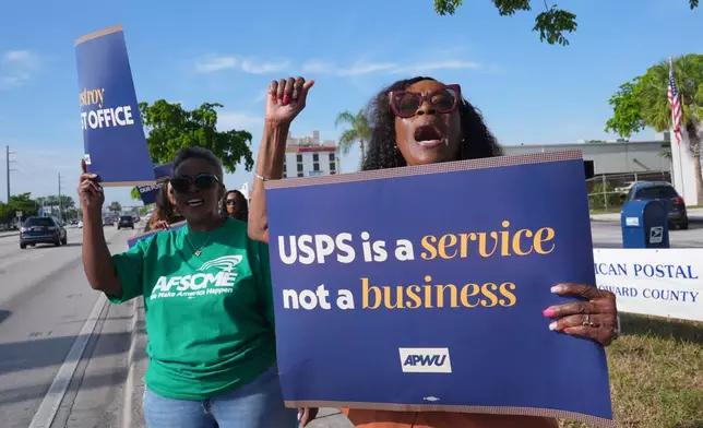 Joy L. Jackson, right, and Ketha Otis demonstrate against proposed changes to the U. S. Postal Service and President Donald Trump's executive order regarding a mail-in ballots Tuesday, July 28, 2026, in Miami Gardens, Fla.(AP Photo/Marta Lavandier)