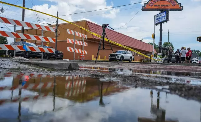 Police work on Canal Street in Houston, Tuesday, July 7, 2026, after a shooting. (Jacob Lujan/Houston Chronicle via AP)