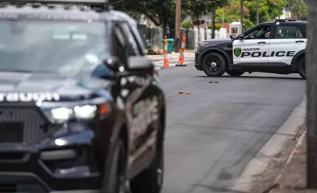 Police work on Canal Street in Houston, Tuesday, July 7, 2026, after a shooting. (Jacob Lujan/Houston Chronicle via AP)