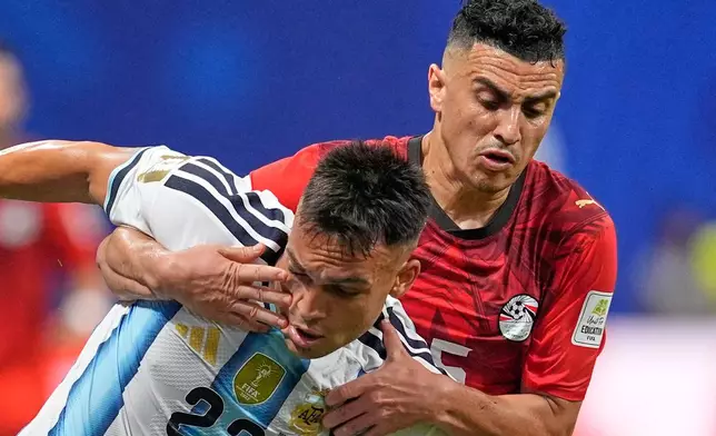 Argentina's Lautaro Martinez (22) is challenged by Egypt's Karim Hafez (15) during the World Cup round of 16 soccer match between Argentina and Egypt in Atlanta, Tuesday, July 7, 2026. (AP Photo/Mike Stewart)