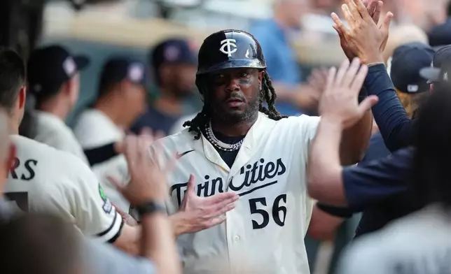 Minnesota Twins' Josh Bell celebrates in the dugout after scoring during the sixth inning of a baseball game against the Athletics, Saturday, July 25, 2026, in Minneapolis. (AP Photo/Ellen Schmidt)