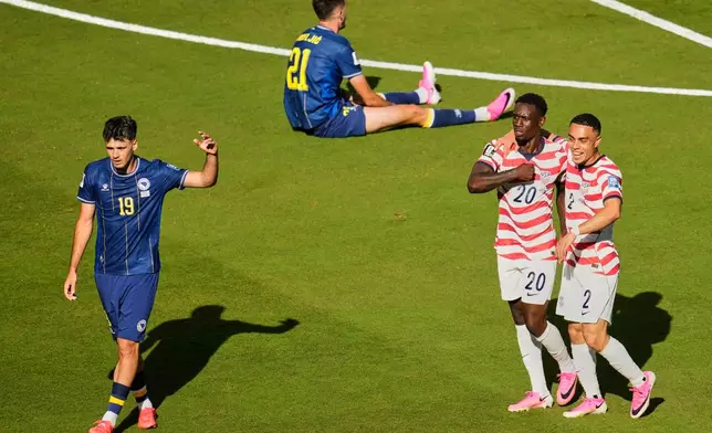 United States' Folarin Balogun (20) celebrates with Sergino Dest (2) after scoring their first goal as Bosnia's Kerim Alajbegovic (19) and Bosnia's Stjepan Radeljic (21) react during the World Cup round of 32 soccer match between the United States and Bosnia in Santa Clara, Calif., near San Francisco, Wednesday, July 1, 2026. (AP Photo/Jeff Chiu)