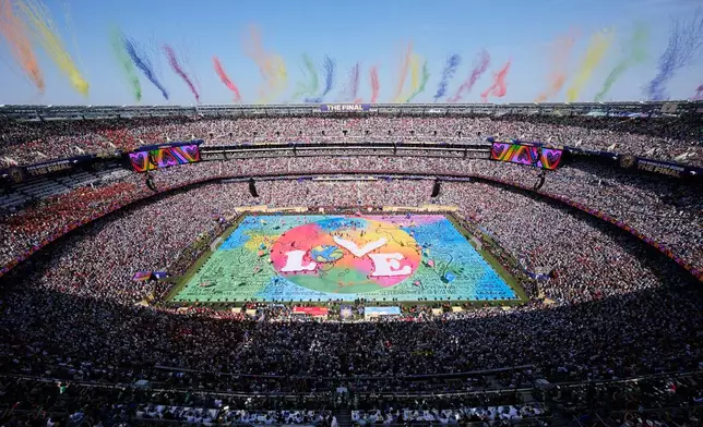 Dancers perform as colorful smoke rises above the stadium during the halftime show at the World Cup final soccer match between Spain and Argentina in East Rutherford, N.J., near New York, Sunday, July 19, 2026. (AP Photo/Matt Slocum)