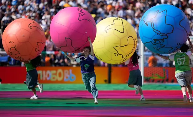 Children run on the pitch during the halftime show of during the World Cup final soccer match between Spain and Argentina in East Rutherford, N.J., near New York, Sunday, July 19, 2026. (AP Photo/Ashley Landis)