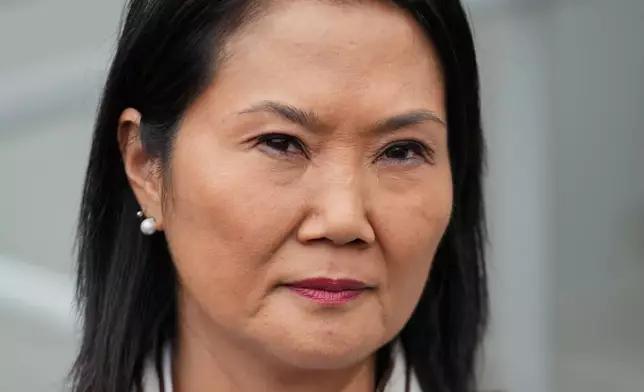 Presidential candidate Keiko Fujimori, of the Popular Force party, listens to a question from a journalist outside her headquarters in Lima, Peru, Friday, June 19, 2026. (AP Photo/Martin Mejia)