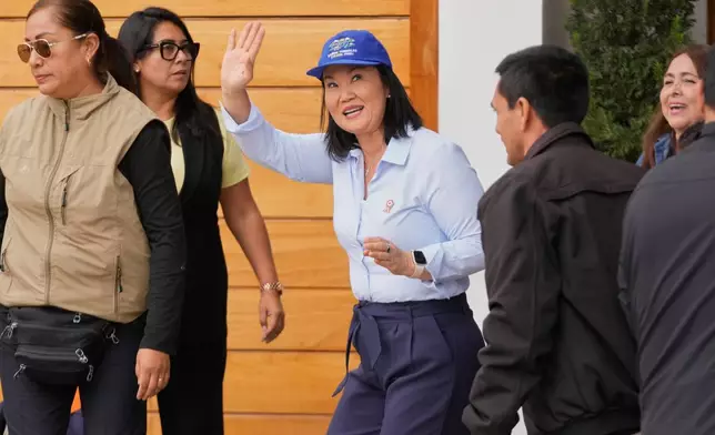 President-elect Keiko Fujimori, waves to reporters as she leaves her home in Lima, Peru, Friday, July 3, 2026. (AP Photo/Martin Mejia)