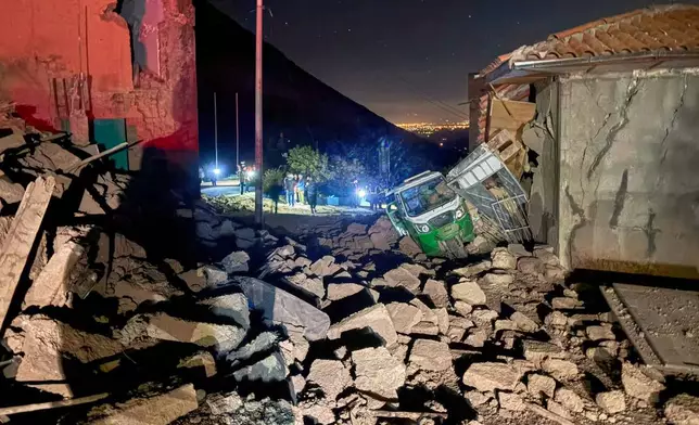 A motor tricycle is stuck amid the debris of homes that collapsed after an earthquake struck Pumpuya, Peru, Sunday, July 19, 2026. ( AP Photo/Jhefry Sedano)