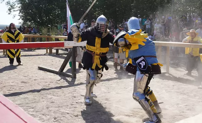 Two fighters battle during the International Medieval Combat Federation's World Championship at Spottrup Castle, in Spottrup, Denmark, Thursday, July 23, 2026. (AP Photo/James Brooks)