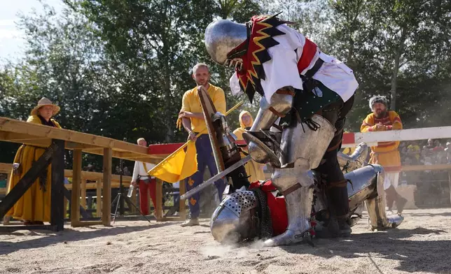 Two fighters battle during the International Medieval Combat Federation's World Championship at Spottrup Castle, in Spottrup, Denmark, Thursday, July 23, 2026. (AP Photo/James Brooks)