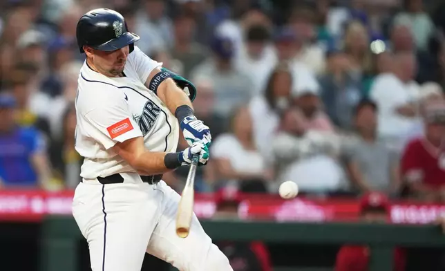 Seattle Mariners' Cal Raleigh hits a grand slam against the Cincinnati Reds during the seventh inning of a baseball game, Monday, July 20, 2026, in Seattle. (AP Photo/Lindsey Wasson)