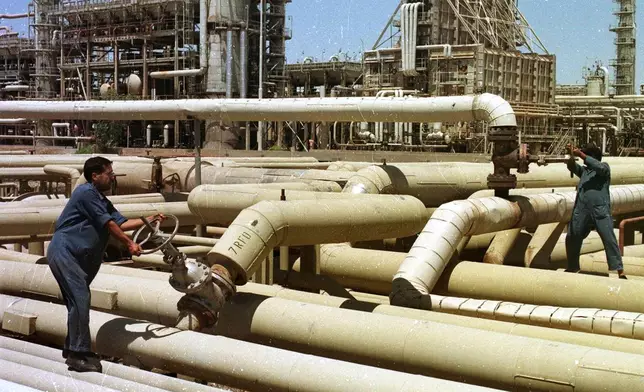 FILE - Iraqi oil workers at an oil installation at Beiji in northern Iraq Tuesday, February 29, 2000. (AP Photo/Jassim Mohammed, File)