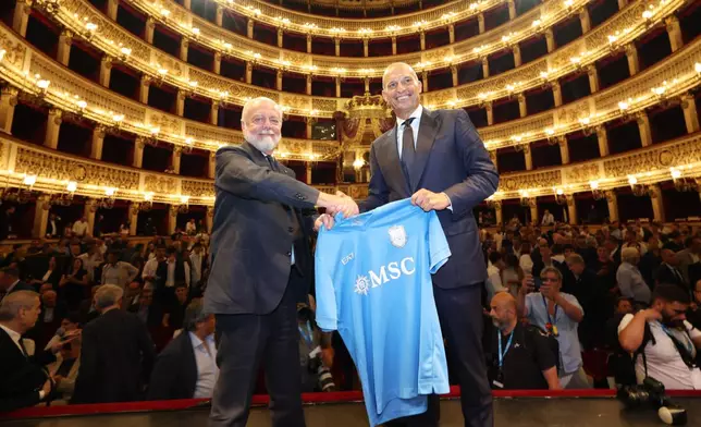The new SSC Napoli coach, Massimiliano Allegri, right, holds a club's jersey with club president Aurelio De Laurentiis, during a presentation press conference at the San Carlo Theater, in Naples, Italy, Tuesday, July 14, 2026. (Alessandro Garofalo/LaPresse via AP)