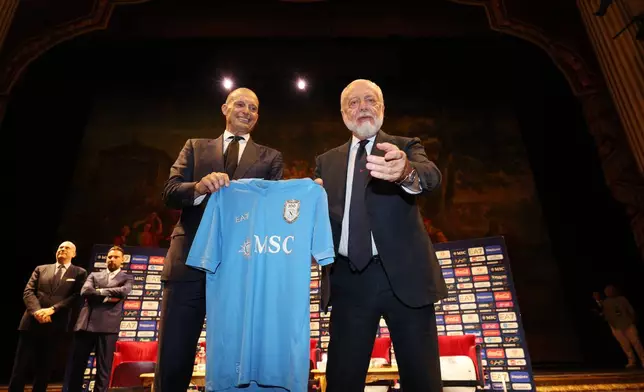 The new SSC Napoli coach, Massimiliano Allegri, left, holds a club's jersey with club president Aurelio De Laurentiis, during a presentation press conference at the San Carlo Theater, in Naples, Italy, Tuesday, July 14, 2026. (Alessandro Garofalo/LaPresse via AP)