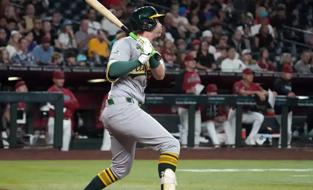 Athletics' Jeff McNeil hits a two-run single against the Arizona Diamondbacks in the seventh inning of a baseball game, Monday, July 20, 2026, in Phoenix. (AP Photo/Rick Scuteri)
