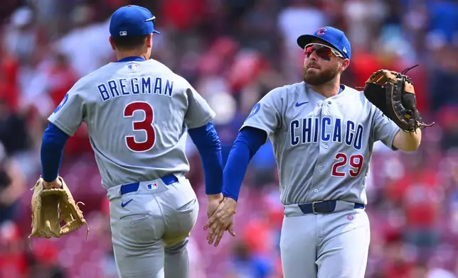 Chicago Cubs' Alex Bregman, left, and Michael Busch celebrate following a baseball game against the Cincinnati Reds in Cincinnati, Sunday, July 12, 2026. (AP Photo/Ben Jackson)