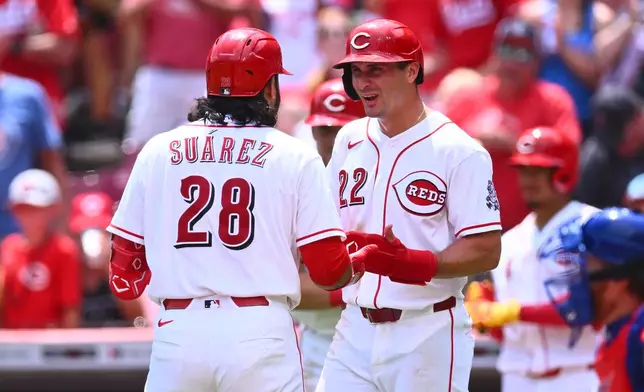 Cincinnati Reds' Eugenio Suárez, left, celebrates with JJ Bleday, right, after hitting a two-run home run during the third inning of a baseball game against the Chicago Cubs in Cincinnati, Sunday, July 12, 2026. (AP Photo/Ben Jackson)