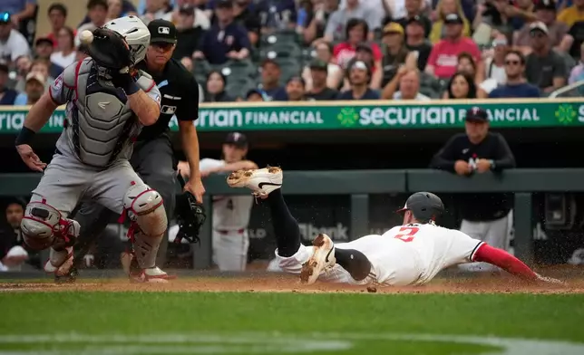 Minnesota Twins' Kody Clemens (2) scores on a sacrifice fly by Luke Keaschall during the fourth inning of a baseball game against the Cleveland Guardians, Wednesday, July 8, 2026, in Minneapolis. (AP Photo/Joseph Scheller)