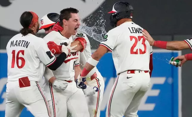 Minnesota Twins' Alan Roden, center left, celebrates with teammates after hitting a walk-off RBI single scoring Royce Lewis in the ninth inning of a baseball game against the Cleveland Guardians, Wednesday, July 8, 2026, in Minneapolis. (AP Photo/Joseph Scheller)