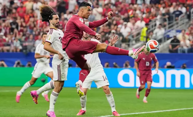 Portugal's Cristiano Ronaldo (7) shoots at the goal in front of Spain's Marc Cucurella (24), left during the World Cup round of 16 soccer match between Portugal and Spain in Arlington, Texas, near Dallas, Monday, July 6, 2026. (AP Photo/Tony Gutierrez)