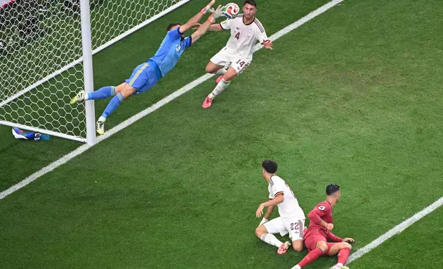 Spain's goalkeeper Unai Simon (23) saves the ball during the World Cup round of 16 soccer match between Portugal and Spain in Arlington, Texas, near Dallas, Monday, July 6, 2026. (AP Photo/Jessica Tobias)