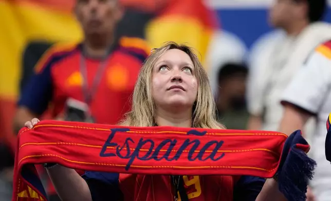 A fan of Spain holds a banner before the World Cup round of 16 soccer match against Portugal in Arlington, Texas, near Dallas, Monday, July 6, 2026. (AP Photo/Ashley Landis)