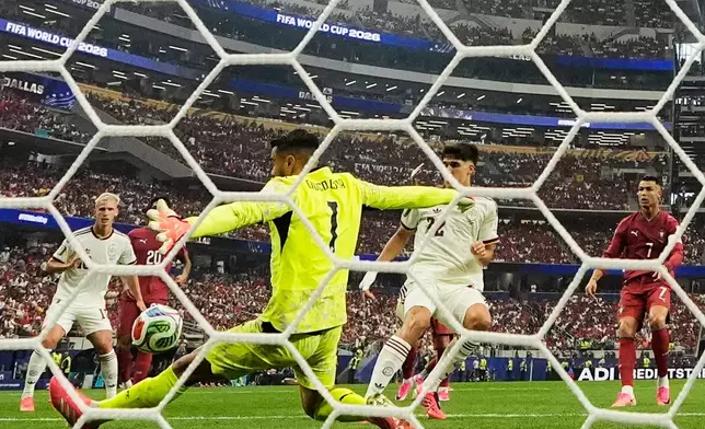 Portugal goalkeeper Diogo Costa (1) makes a save during the World Cup round of 16 soccer match between Portugal and Spain in Arlington, Texas, near Dallas, Monday, July 6, 2026. (AP Photo/Ashley Landis)