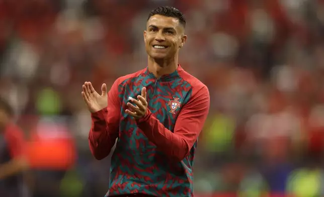Portugal's Cristiano Ronaldo (7) cowalks out for the warm up before the World Cup round of 16 soccer match between Portugal and Spain in Arlington, Texas, near Dallas, Monday, July 6, 2026. (AP Photo/Gareth Patterson)