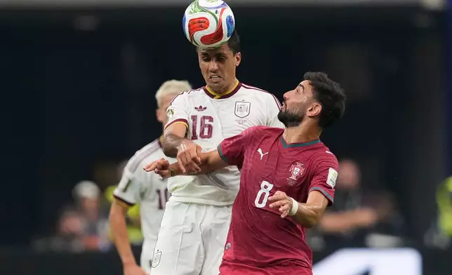 Spain's Rodri (16) and Portugal's Bruno Fernandes (8) challenge for the ball during the World Cup round of 16 soccer match between Portugal and Spain in Arlington, Texas, near Dallas, Monday, July 6, 2026. (AP Photo/Tony Gutierrez)
