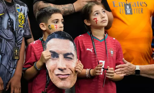 Young fans hold a photo of Portugal's Cristiano Ronaldo before the World Cup round of 16 soccer match against Spain in Arlington, Texas, near Dallas, Monday, July 6, 2026. (AP Photo/Ashley Landis)