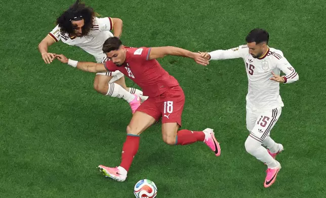 Portugal's Pedro Neto, center, tries to get past Spain's Marc Cucurella, left, and Álex Baena during the World Cup round of 16 soccer match between Portugal and Spain in Arlington, Texas, near Dallas, Monday, July 6, 2026. (AP Photo/Sam Hodde)