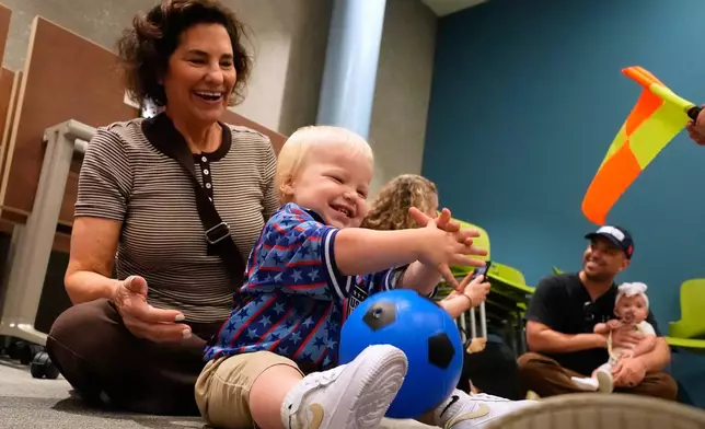 Briggs Graham, age 1, plays with a soccer ball at a program introducing toddlers to the sport ahead of the World Cup soccer tournament Thursday, June 4, 2026, in Lenexa, Kan. (AP Photo/Charlie Riedel)