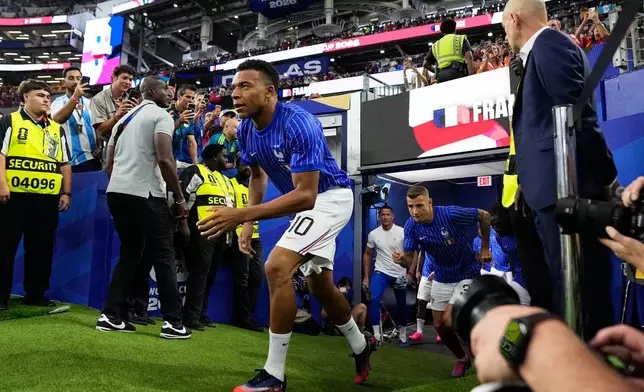 France's Kylian Mbappe runs on to the pitch for warmup before the World Cup semifinal soccer match between France and Spain in Arlington, Texas, near Dallas, Tuesday, July 14, 2026. (AP Photo/Ashley Landis)