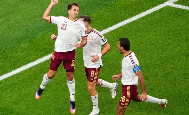 Spain's Mikel Oyarzabal (21) celebrates his goal on a penalty kick with Fabian Ruiz (8), and Rodri (16) during the World Cup semifinal soccer match between France and Spain in Arlington, Texas, near Dallas, Tuesday, July 14, 2026. (AP Photo/David J. Phillip)