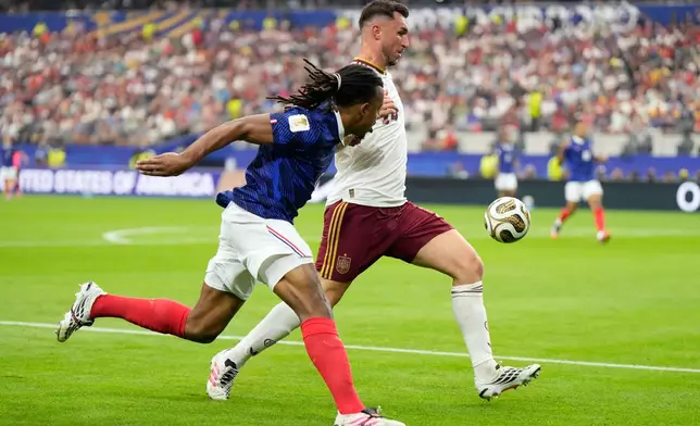 France's Jules Kounde, left, vies for the ball with Spain's Aymeric Laporte during the World Cup semifinal soccer match between France and Spain in Arlington, Texas, near Dallas, Monday, July 14, 2026. (AP Photo/Ashley Landis)