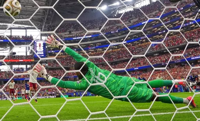 Spain's Mikel Oyarzabal (21) scores their first goal on a penalty kick past France goalkeeper Mike Maignan (16) during the World Cup semifinal soccer match between France and Spain in Arlington, Texas, near Dallas, Tuesday, July 14, 2026. (AP Photo/Julio Cortez)