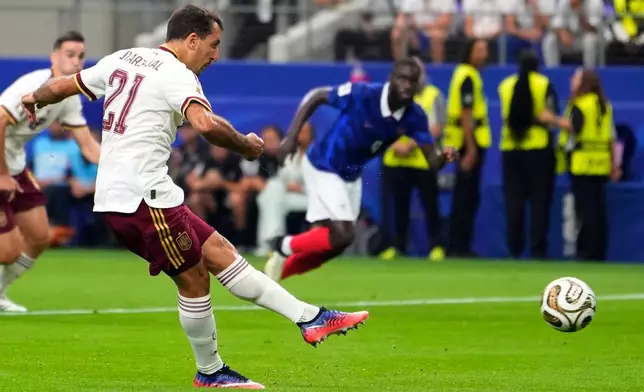 Spain's Mikel Oyarzabal (21) scores his side's first goal on a penalty kick during the World Cup semifinal soccer match between France and Spain in Arlington, Texas, near Dallas, Tuesday, July 14, 2026. (AP Photo/Tony Gutierrez)