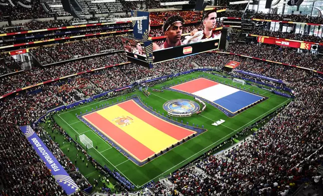 Spanish and French flags are seen on the pitch during the presentation of the teams before the World Cup semifinal soccer match between France and Spain in Arlington, Texas, near Dallas, Tuesday, July 14, 2026. (AP Photo/Sam Hodde)