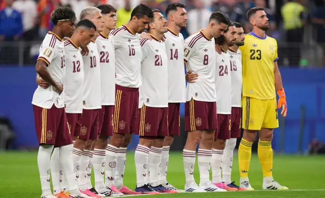 Members of team Spain stand during a moment of silence prior to the World Cup semifinal soccer match between France and Spain in Arlington, Texas, near Dallas, Tuesday, July 14, 2026. (AP Photo/Eric Gay)