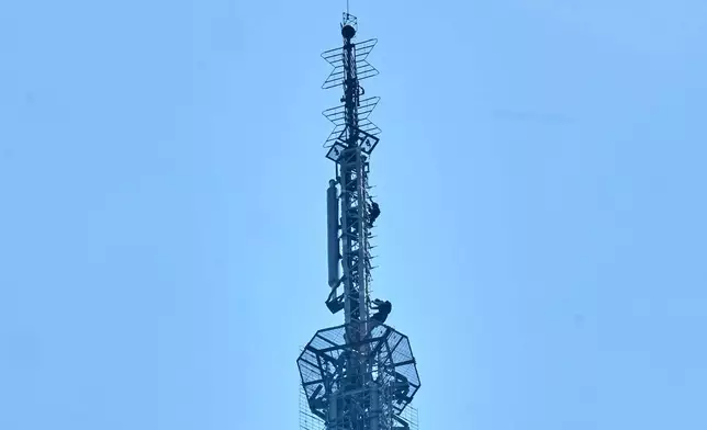 Two people descend the spire of the Empire State Building, in New York, Wednesday, July 1, 2026. (AP Photo/Richard Drew)