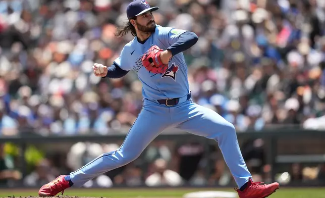 Toronto Blue Jays pitcher Dylan Cease throws against the San Francisco Giants during the first inning of a baseball game Wednesday, July 8, 2026, in San Francisco. (AP Photo/Jeff Chiu)