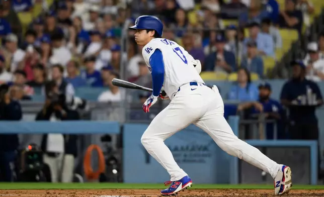 Los Angeles Dodgers' Shohei Ohtani runs after hitting a two-run single during the fourth inning of a baseball game against the Colorado Rockies in Los Angeles, Monday, July 6, 2026. (AP Photo/Kyusung Gong)