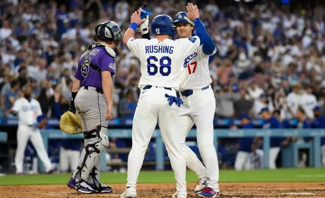 Los Angeles Dodgers' Shohei Ohtani (17) celebrates with Dalton Rushing (68) after hitting a two-run home run during the third inning of a baseball game against the Colorado Rockies in Los Angeles, Monday, July 6, 2026. (AP Photo/Kyusung Gong)
