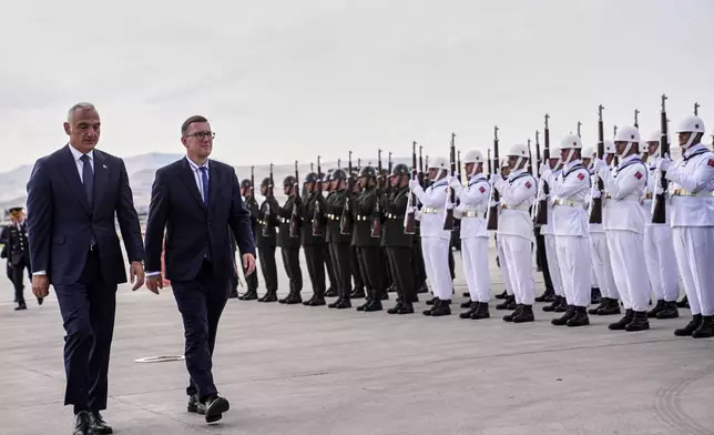 Estonia's Prime Minister Kristen Michal, center left, walks with Turkish Culture and Tourism Minister Mehmet Nuri Ersoy, left, during airport arrivals ahead of the NATO Summit in Ankara, Turkey, Monday, July 6, 2026. (Metin Aktas, Pool Photo via AP)