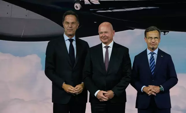 From left, NATO Secretary General Mark Rutte, President and CEO of Saab Micael Johansson and Sweden's Prime Minister Ulf Kristersson during the NATO Defense Industry Forum at the NATO summit in Ankara, Turkey, Tuesday, July 7, 2026. (AP Photo/Hussein Malla)