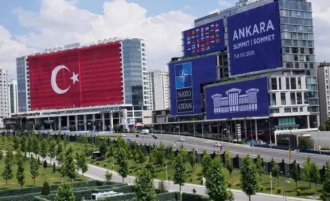 A Turkish flag and NATO banners cover buildings ahead of the NATO Summit in Ankara, Turkey, Monday, July 6, 2026. (AP Photo/Hussein Malla)