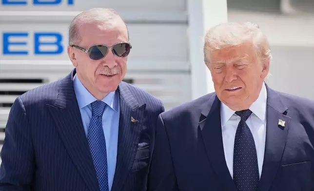 President Donald Trump walks with Turkish President Recep Tayyip Erdogan, left, upon arriving for the NATO summit in Ankara, Turkey, Tuesday, July 7, 2026. (AP Photo/Alex Brandon)