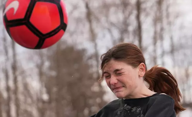 FILE - Parker Tirrell, a transgender athlete who plays on her high school's girls soccer team, heads the ball, Friday, March 7, 2025, in Plymouth, N.H. (AP Photo/Charles Krupa, File)