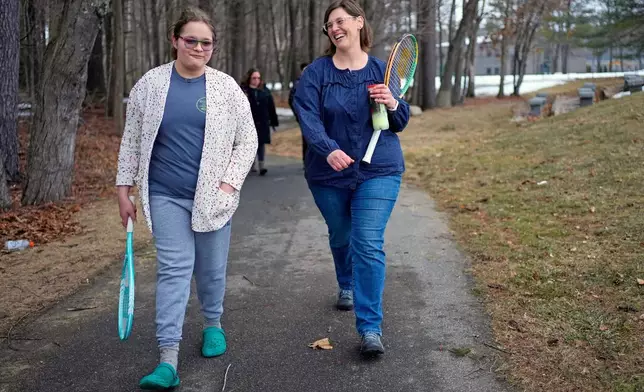 FILE - Iris Turmelle walks with her mom, Amy Manzelli, near her high school's tennis courts, Wednesday, March 5, 2025, in Pembroke, N.H. (AP Photo/Robert F. Bukaty, File)